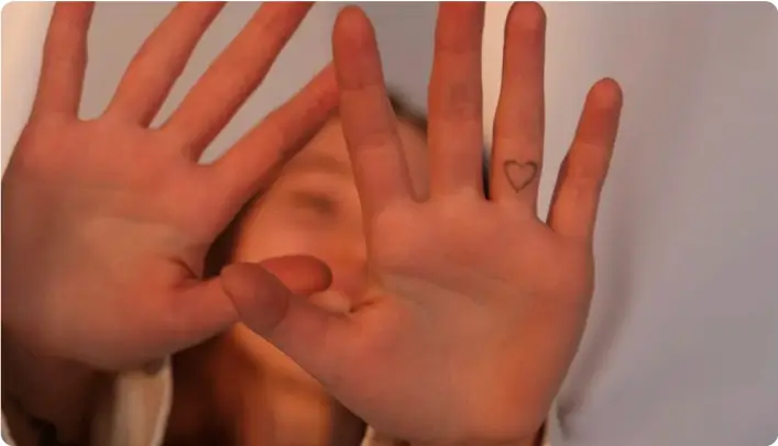 Hand with a finger tattoo